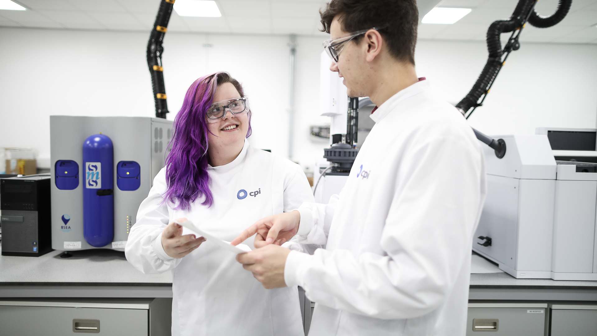 Photo of two CPI scientists smiling at each other Photo of two CPI scientists smiling at each other