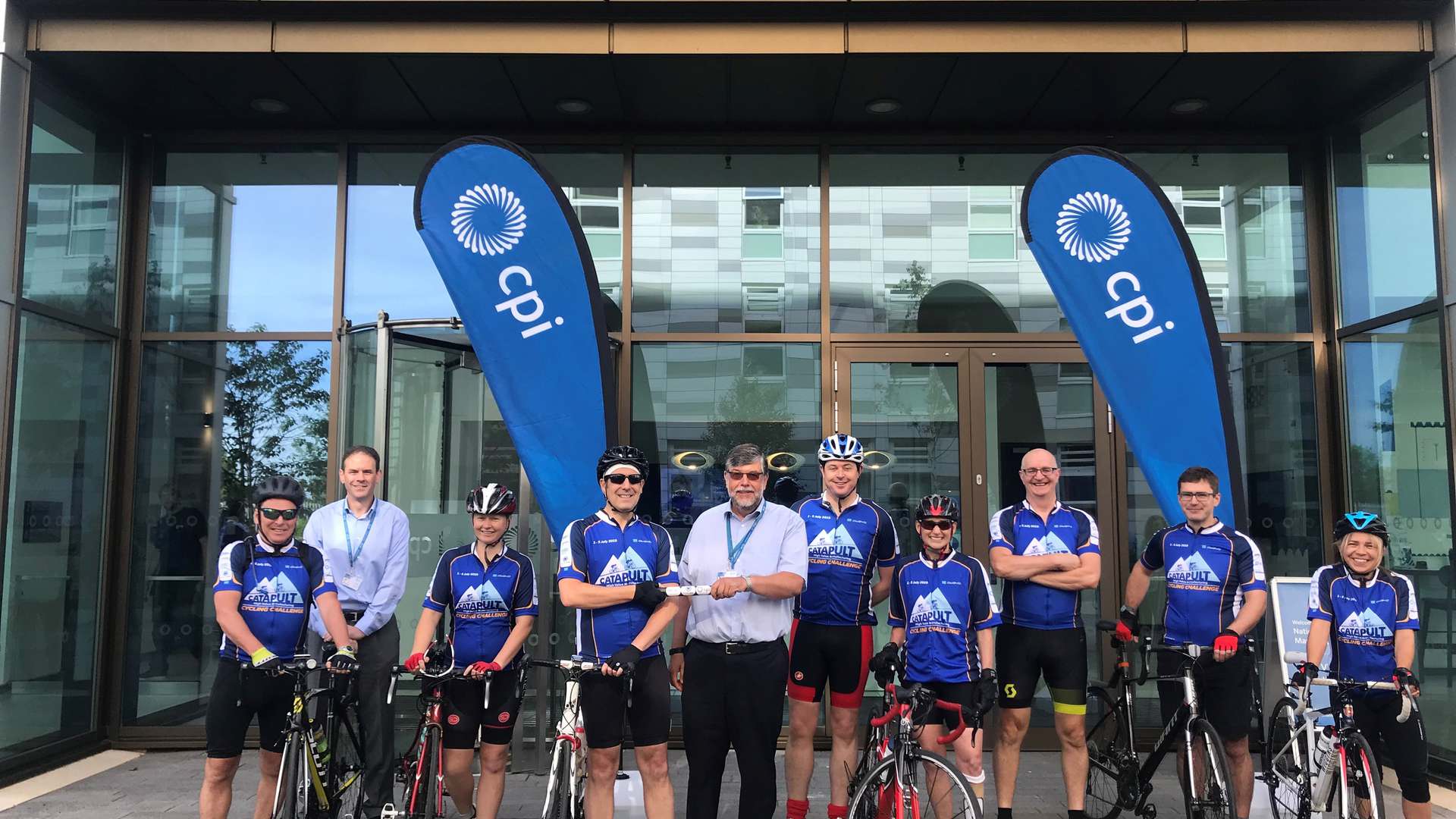 CPI cyclists with CPI's COO Frank Millar and CEO Nigel Perry receiving the baton which is being passed between all HVMC Centres on the route CPI cyclists with CPI's COO Frank Millar and CEO Nigel Perry receiving the baton which is being passed between all HVMC Centres on the route
