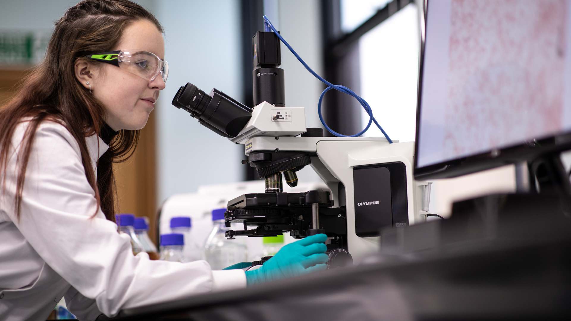 CPI expert looking through a microscope. CPI expert looking through a microscope.