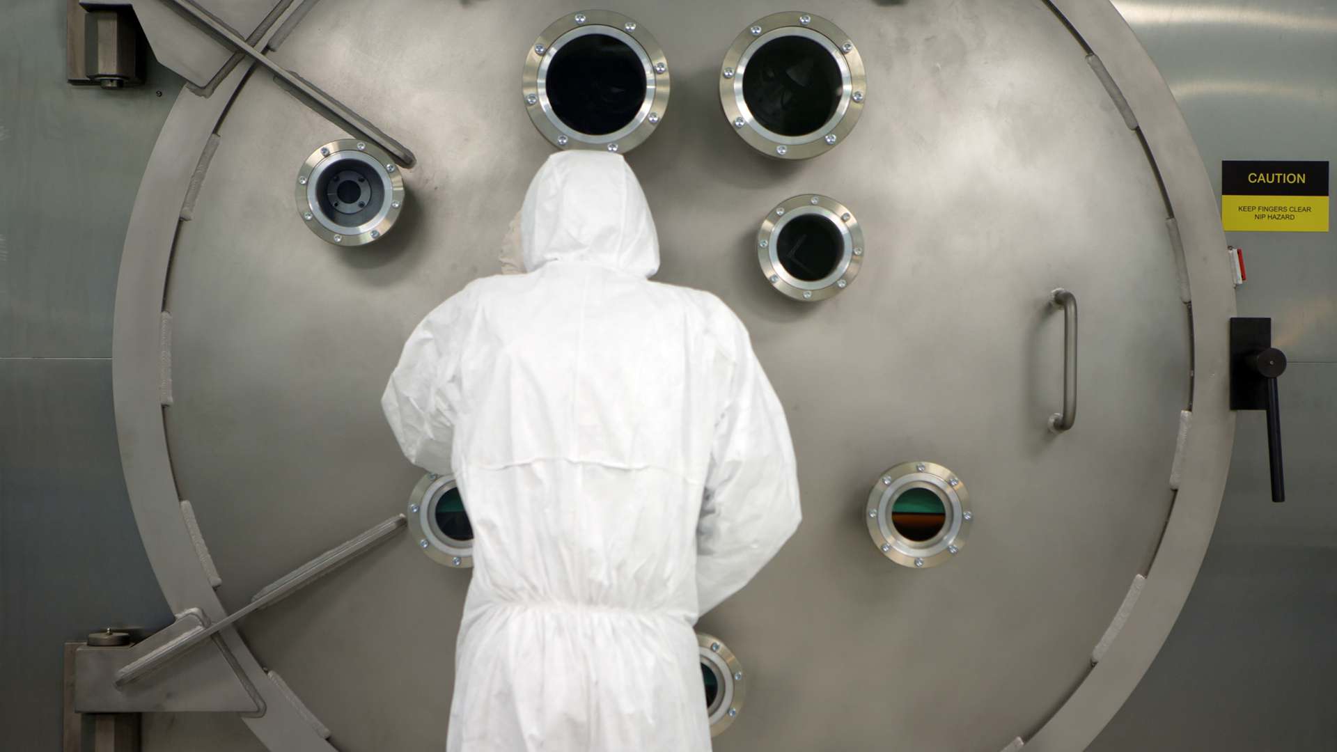 A photo of a CPI staff member using a large area atomic layer deposition equipment in a cleanroom A photo of a CPI staff member using a large area atomic layer deposition equipment in a cleanroom