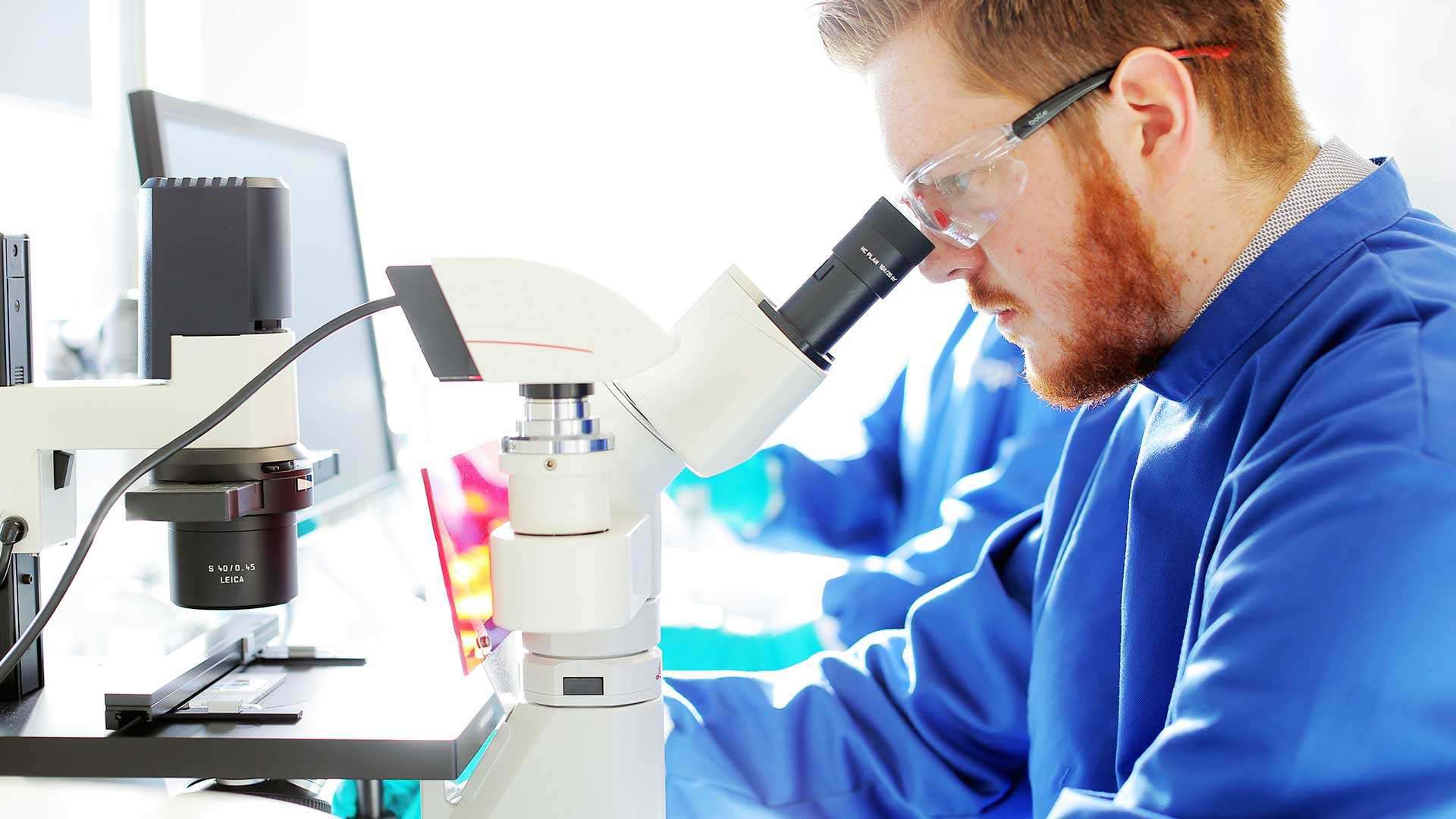 Photo of a scientist running experiment in a lab Photo of a scientist running experiment in a lab