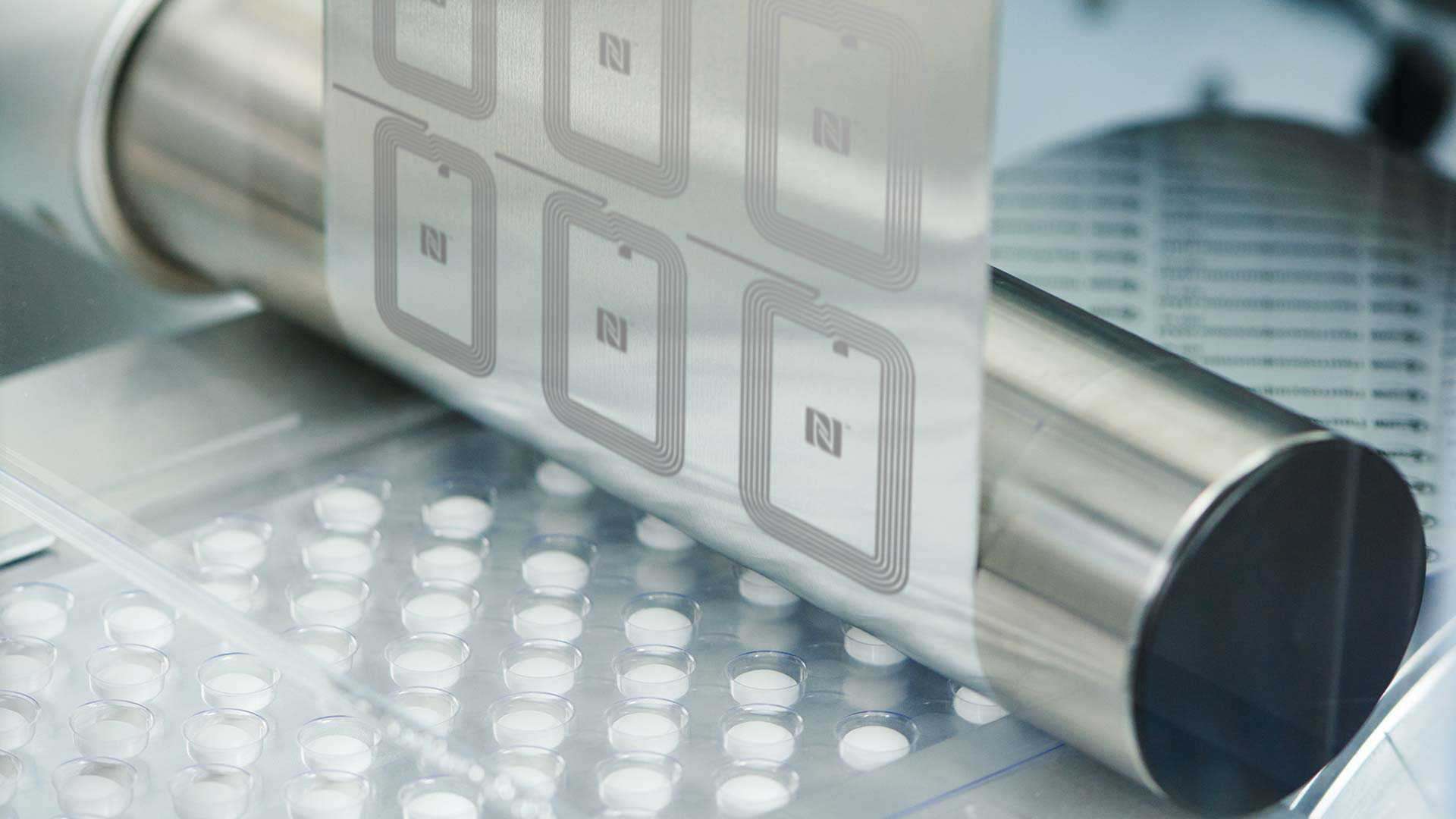 A photo of a NFC-embedded printed circuit being applied to a product being manufactured A photo of a NFC-embedded printed circuit being applied to a product being manufactured